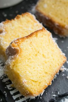 two pieces of cake sitting on top of a cooling rack covered in powdered sugar