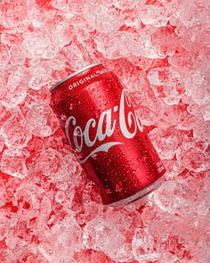 a can of coca cola sitting on top of ice