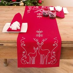 a red table runner with white designs on it