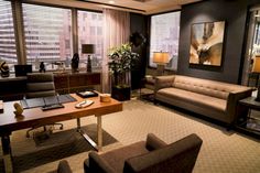 a living room filled with furniture and windows covered in shades of brown, tan and black