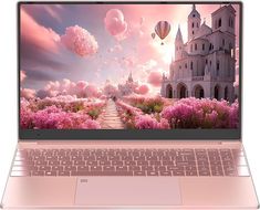 an open laptop computer sitting on top of a white table next to a pink flower field