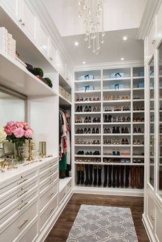 a walk in closet filled with lots of white drawers and shoes on top of shelves