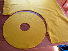 a yellow piece of cloth sitting on top of a wooden floor