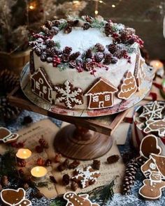 there is a cake decorated with gingerbreads and other decorations on top of the table