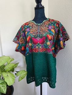 PRE LOVED in great condition. Machine embroidered It fits sizes L to 1X. Model normally wears size 8 US Approximate Measurement: Armpit to armpit 27.5 Inches wide 55 Inches all around 26 Inches long Check Sizing Guide – Saviaguate Bright Green San Juan Comalapa Mayan Top: A Tapestry of Tradition Description: Our Bright Green Mayan Top from San Juan Comalapa is a vibrant masterpiece that weaves together ancient motifs and contemporary style. Here are the details that make it truly remarkable: Col Green Floral Embroidered Crew Neck Blouse, Green Embroidered Crew Neck Blouse, Green Embroidered Relaxed Fit Blouse, Green Crew Neck Blouse With Floral Embroidery, Green Embroidered Blouse With Relaxed Fit, Green Blouse With Floral Embroidery And Relaxed Fit, Summer Green Tops With Intricate Embroidery, Green Tops With Intricate Embroidery For Summer, Bohemian Green Embroidered Hem Top