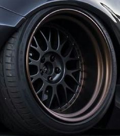 the front wheel of a black sports car