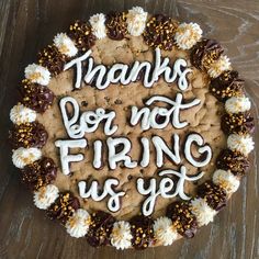 a cake with frosting and sprinkles on it that says thanks for not firing us yet