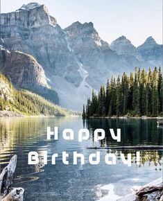 a birthday card with the words happy birthday in front of a mountain lake and pine trees