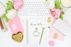 pink and white desk with flowers, notepad, pen, keys, money, heart shaped keychain