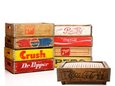 four wooden crates stacked on top of each other with coca - cola signs in them