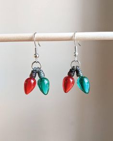 "A mini and beautiful cluster of Christmas tree lights. These highlight the two traditional Christmas colors of red and green. Each bulb is small (3/4 \") making these earrings lightweight. They are perfect for minimalists and little ears such as children. These would be awesome to wear all season long! These come on silver nickel free ear wires. They dangle down about 1\" from the top of the ear wire. Comes with 2 hypoallergenic silicone backings. To see more seasonal earrings: https://Grizzlyb Christmas Light Earrings, Xmas Jewelry, Christmas Tree Lights, Xmas Lights, Tree Lights, Light Earrings, Green Jewelry, Mini Christmas, Earrings Red