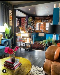 a living room filled with lots of furniture and colorful accessories on top of a wooden table