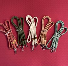 five different colored cords with metal clasps on each end and one string attached to the other