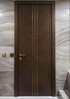 the door is brown in color and has gold trimmings on it, along with some stairs