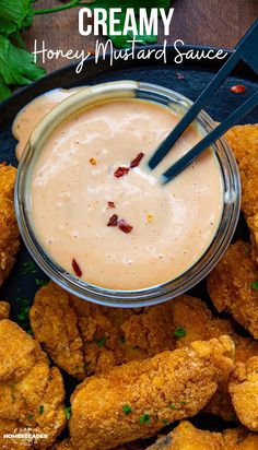 chicken wings and dipping sauce in a bowl with the words, creamy honey mustard sauce