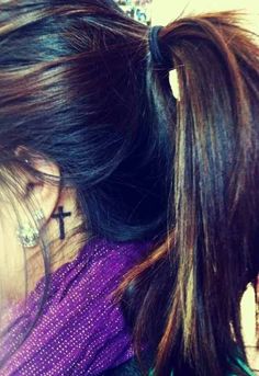 a girl with a cross tattoo on her neck