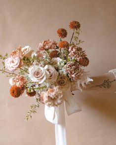 a white vase filled with lots of flowers