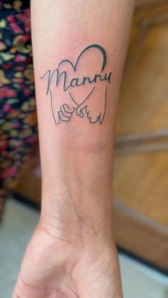 a woman's arm with a tattoo on it that says, mama and son