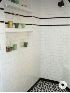 a black and white tiled bathroom with shelves