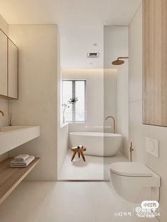 a bathroom with a white bath tub sitting next to a toilet