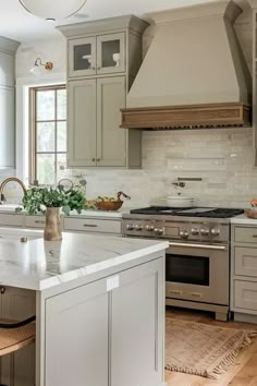 a large kitchen with an island in the middle and lots of cabinets on both sides