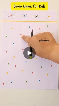 a hand is pointing at a piece of paper with the words brain game for kids on it