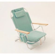 a lawn chair with a wooden armrest and blue fabric on the back, in front of a white background