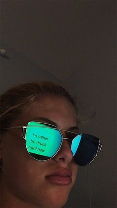 a woman wearing sunglasses with glow in the dark on her face and words written on them