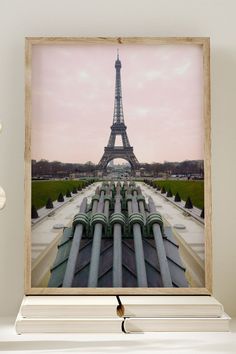 the eiffel tower in paris is seen through an open wooden frame on a shelf