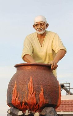 an old man standing next to a large pot with flames on it's side