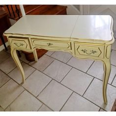 a white desk with drawers on top of it in the middle of a tiled floor