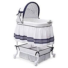 a white crib with blue trimmings and a black bow on the top