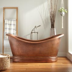 an old fashioned copper bath tub in a bathroom