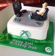 a birthday cake that looks like it has a person laying on the bed in front of a computer