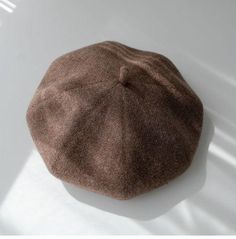 a brown hat sitting on top of a white table