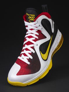 the nike zoom basketball shoe is red, yellow and white