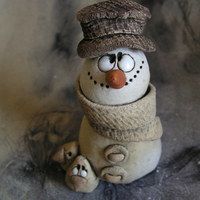 a snowman figurine with a hat and scarf