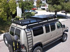 the vehicle is parked on the side of the road with its roof rack attached to it