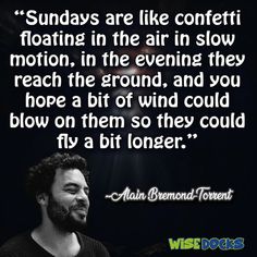 a man in black shirt and beard with quote about sun rays are like confetti floating in the air in slow motion