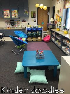 a classroom with blue tables and colorful chairs