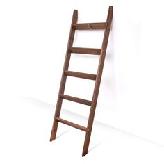 a wooden ladder leaning up against a wall