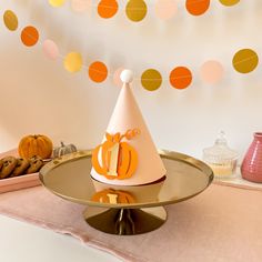 a party hat sitting on top of a cake plate