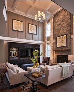 a living room filled with furniture and a fire place in the middle of a room