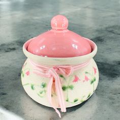 a pink covered dish sitting on top of a counter