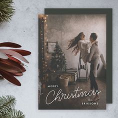 a merry christmas card with a couple dancing