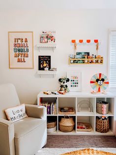 a living room filled with lots of furniture and pictures on the wall above it's bookshelf