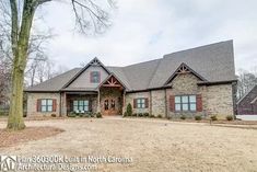 a large brick house sitting on top of a dirt field