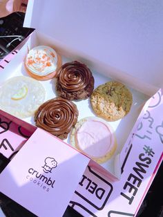 a box filled with different types of donuts