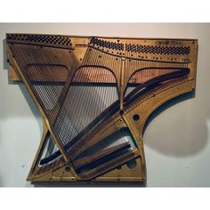 a large wooden instrument with many strings on it