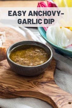 an image of garlic dip in a bowl on a cutting board with bread and flowers